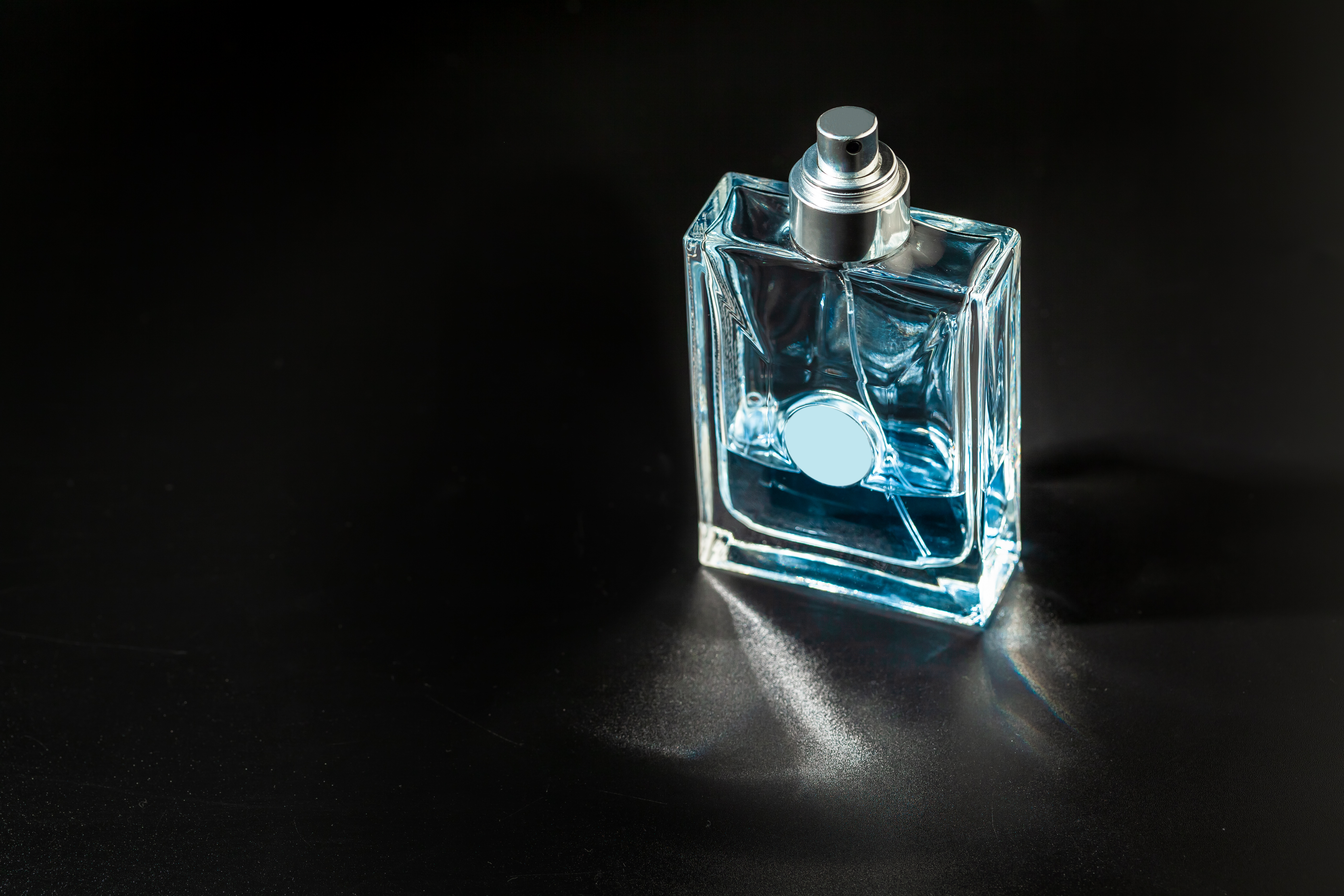 Male perfume bottle with reflections. Perfumery, cosmetics